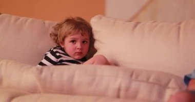 Child watching TV screen. Portrait close-up of young boy staring screen at night