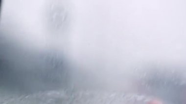 difficult driving conditions. Pov car rain splatters windshield during storm