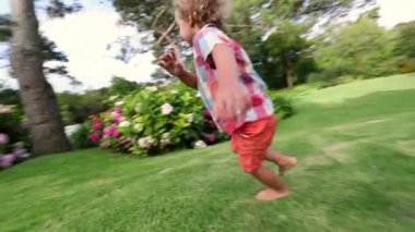 Child running outside in backyard home