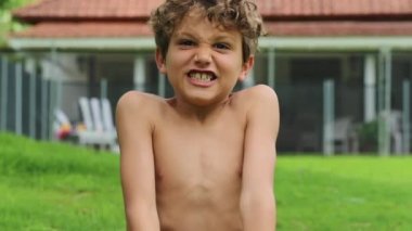 Portrait of young boy yelling roaring from top of his lungs
