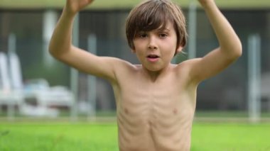 Child screaming to camera yelling then laughing and happy