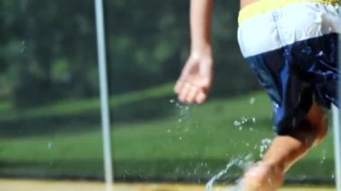 Young boy running by poolside at the pool. Swimming pool setting child having fun getting out of pool