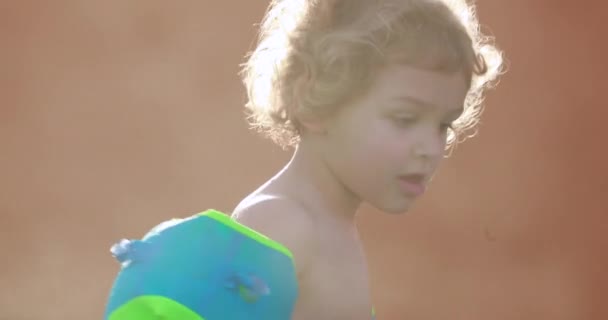 Child Wearing Inflatable Armbands Swimming Pool — Stockvideo