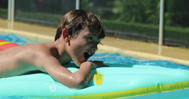 Child Boy Falling Inflatable Mattress Swimming Pool Water — стоковое видео