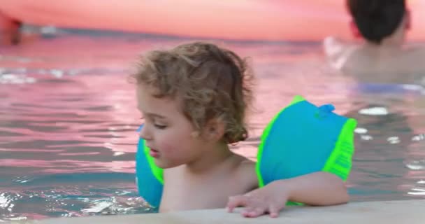Child Wearing Inflatable Armbands Swimming Pool Holding Poolside — Video