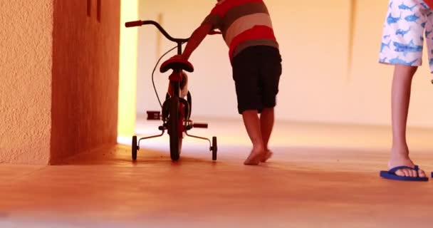 Small Boy Carrying Trycicle Child Learning Ride Trycicle — Videoclip de stoc