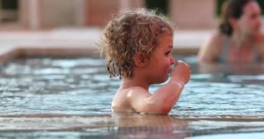 Candid toddler child boy exiting swimming pool