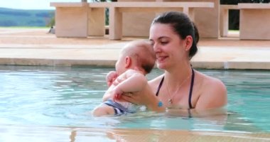 Mother and newborn baby at the swimming pool