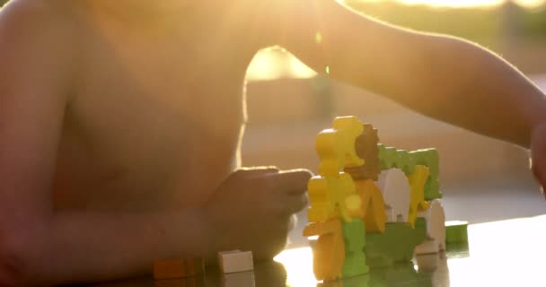 Small Boy Playing Toys Sunlight Puzzle Piece Falling — Video
