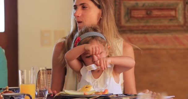 Little Girl Eating Lunch Holding Fork Mother Lap Candid Child — Stock video