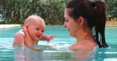 Mother and baby son at the swimming pool