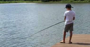 Young boy at lake fishing child outdoor leisure activity