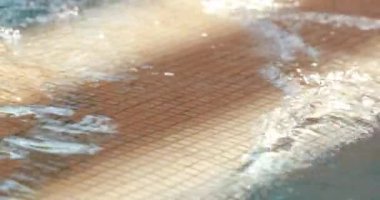 Swimming pool water texture surface in slow-motion