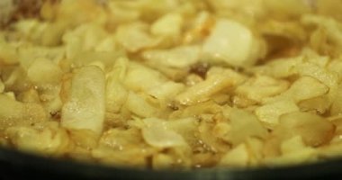 Frying potatoes on large pan