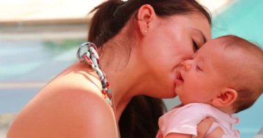 Love and affection, mother cuddling newborn baby outdoors