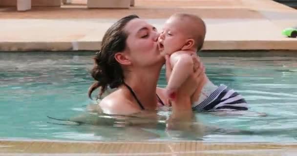 Mother Kissing Newborn Baby Son Swimming Pool Water — Stockvideo