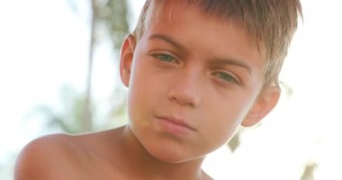 Portrait of young boy child becoming serious chainging emotion