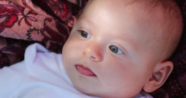 Happy cute newborn baby infant laid in ground outside