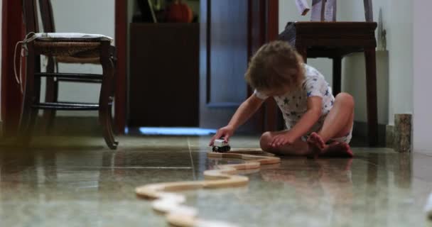 Little Boy Playing Wooden Railroad Tracks Wagons — стоковое видео