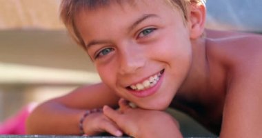 Young boy face smiling posing to camera beautiful kid portrait authentic smile