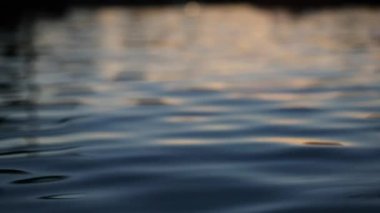 Clear pool water surface during sunset time