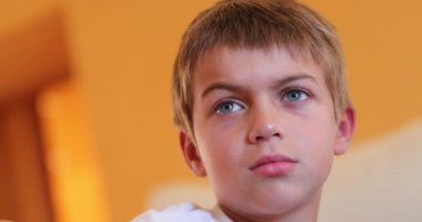 Handsome small boy face watching TV movie hypnotized