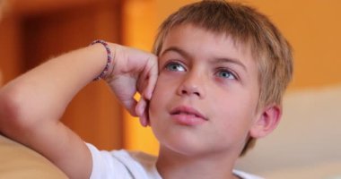 Handsome small boy face watching TV movie hypnotized