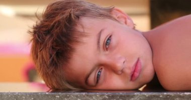 Handsome child young small boy looking to camera outdoors