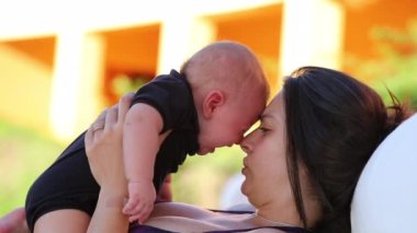 Mother calming embracing upset crying toddler infant baby son outdoors