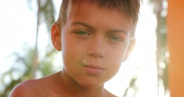Handsome young boy child looking to camera outside looking to camera