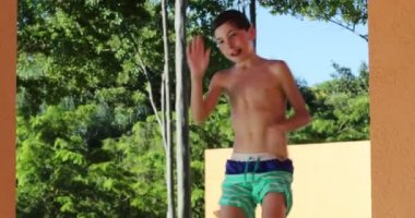 Goofy Little boy dancing at the pool setting