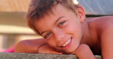 Handsome young boy child face posing to camera smiling