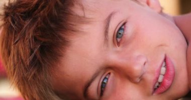 Handsome child young small boy looking to camera outdoors