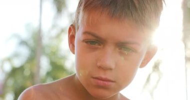 Young boy from serious to happy smiling to camera