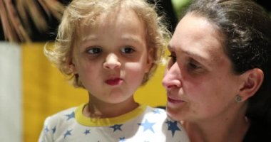 Authentic real life mother and toddler faces together portrait