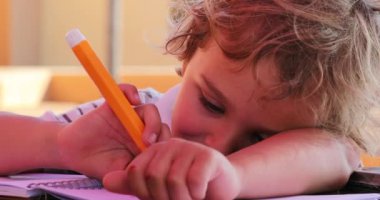 Little boy holding color pen drawing