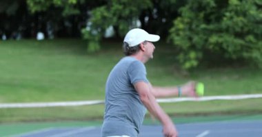 Senior man serving tennis game