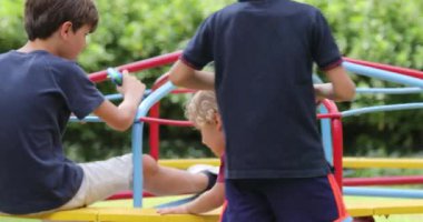 Children at playground with carousel spinning round