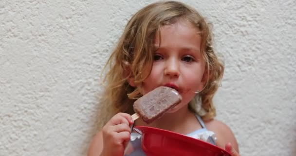 Little Girl Eating Chocolate Ice Cream — Stock Video