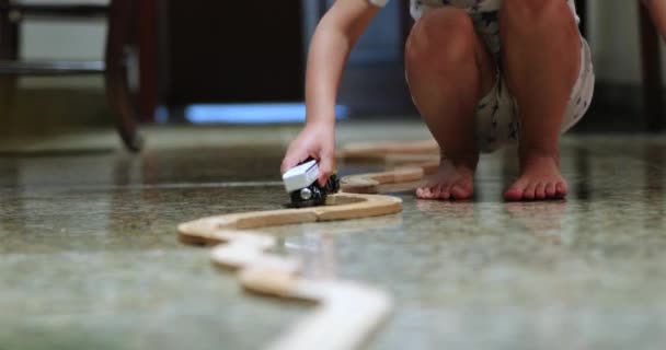 Little Boy Playing Wooden Railroad Tracks Wagons — Stok video