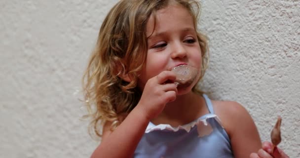 Candid Small Girl Eating Chocolate Ice Cream — Video
