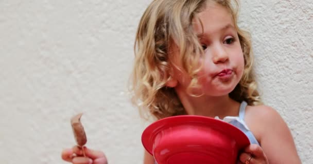 Candid Small Girl Eating Chocolate Ice Cream — Wideo stockowe