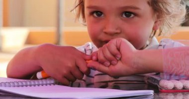 Little boy removing color pen cap about to draw