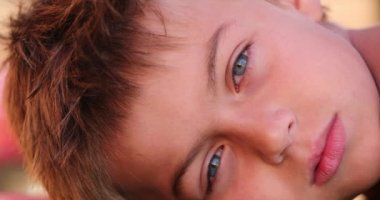 Portrait of handsome young boy kid face smiling to camera authentic smile