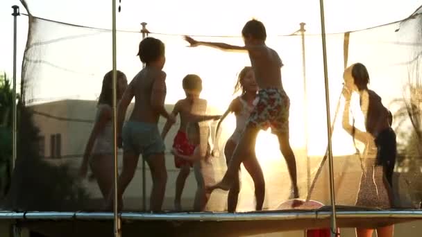 Kids Bouncing Trampoline Outdoors Sunlight Golden Hour Time — Stock Video