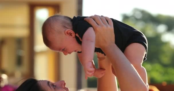 Mom Lifting Baby Son Upwards Outdoors Poolside — Stockvideo