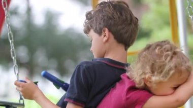 Kids playing at playground swing authentic