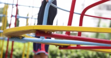 Playground carousel spinning round with kid