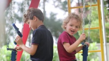 Kids playing at playground swing outside