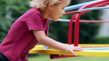 Child playground with carousel spinning round